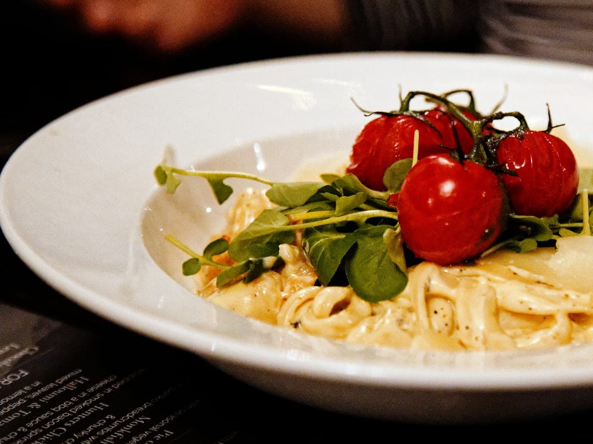 Seafood linguine plated on a rustic restaurant table.
