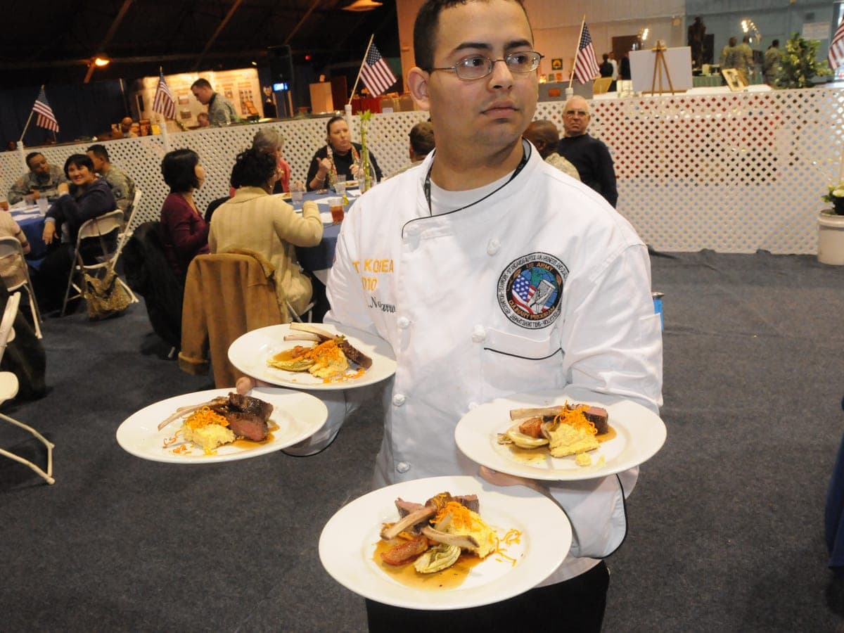 Four finished restaurant plates in a stacked carry — thematic restaurant imagery.